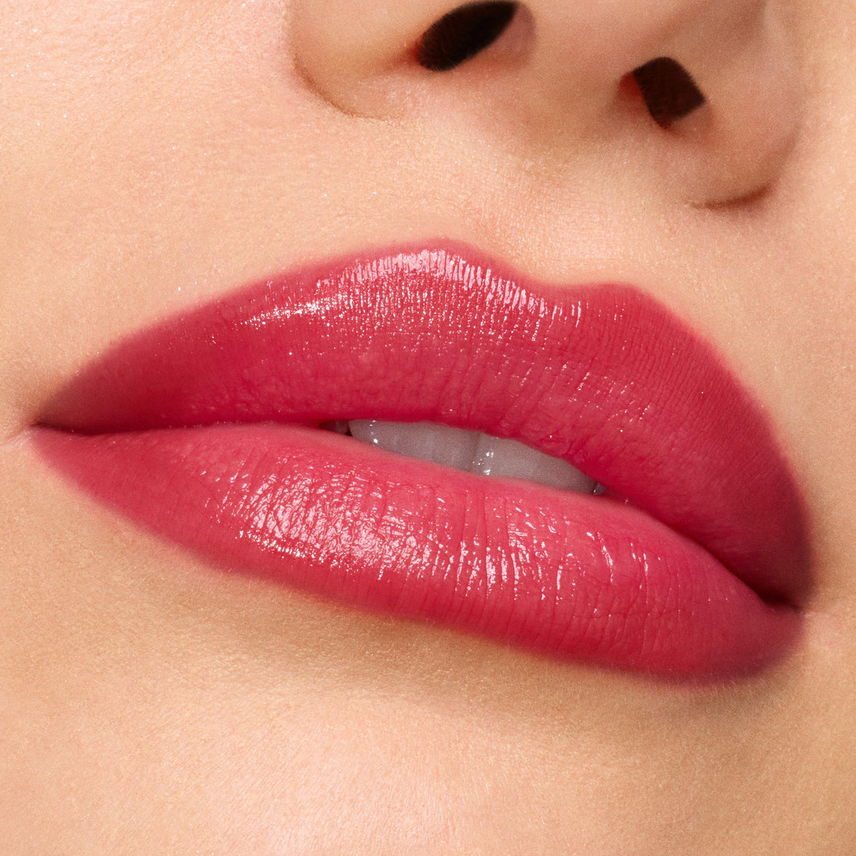 Glossed lips wearing ColourPop So Juicy Plumping Gloss in Spice Level, showing a high-shine, plumped, rosy-red tint; macro close-up emphasizes smooth texture, even coverage, and juicy hydration.