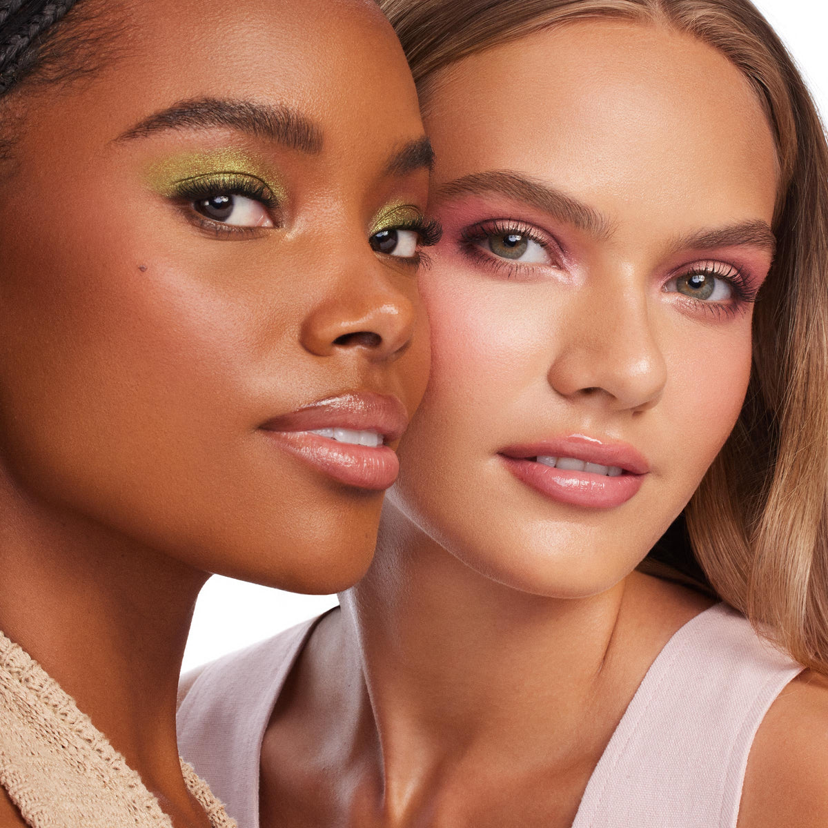 Two models showcase ColourPop Party of Five Super Shock Shadow, wearing shimmery green and soft pink eye looks with glossy lips in a studio close-up, highlighting the creamy, high-impact finish.
