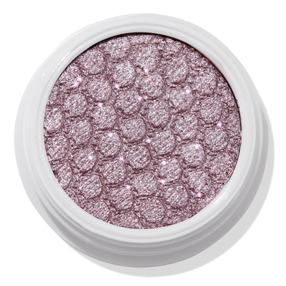 ColourPop The Griffith Super Shock Shadow eyeshadow showing a metallic cool-toned lavender-pink shimmer, pressed with a quilted honeycomb texture in a white round pot, reflecting silver sparkles for high-shine lids.