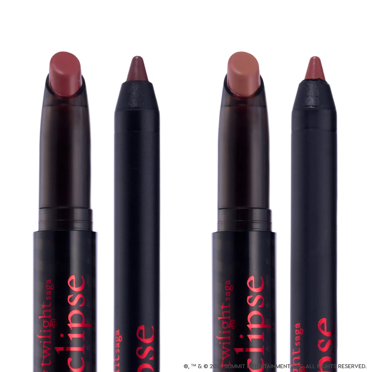 Immortal Kiss Lippie Stix Duo from the Twilight collection standing upright against a white background, showing two creamy mauve-brown lipstick crayons and two matching liners in sleek black tubes with red Eclipse branding.