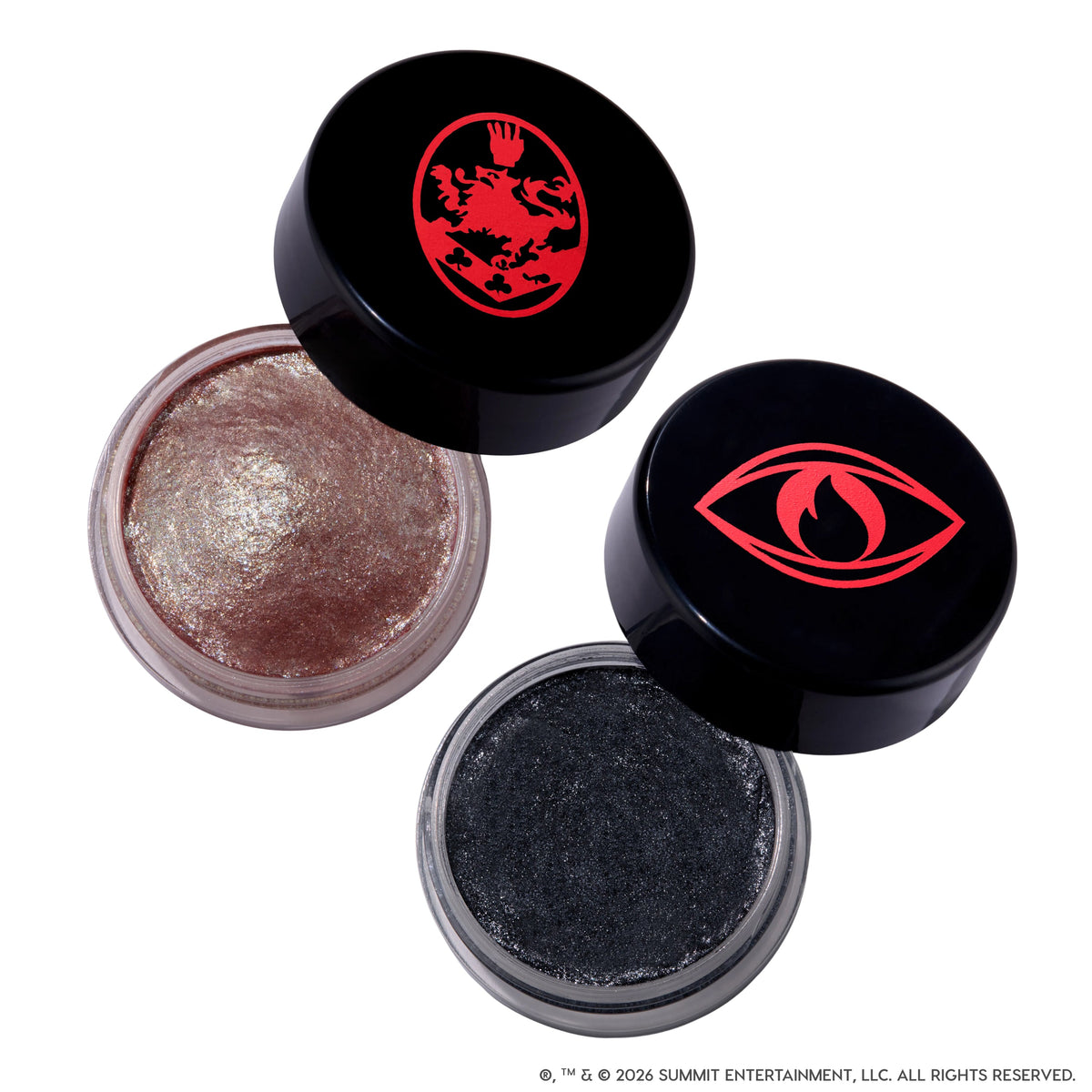 Coven Clash Jelly Much Duo Twilight makeup set showing two open gel eyeshadows, one shimmery rose gold and one sparkly charcoal black, in clear pots with black lids featuring bold red Twilight-inspired crest and eye symbols on a white background.