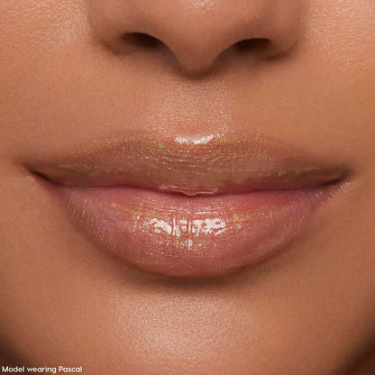 Lips wearing ColourPop Ultra Glossy Lip Pascal, catching studio light in a sheer, high-shine finish with fine iridescent shimmer; extreme close-up beauty shot emphasizing smooth, hydrated lips and glossy payoff.