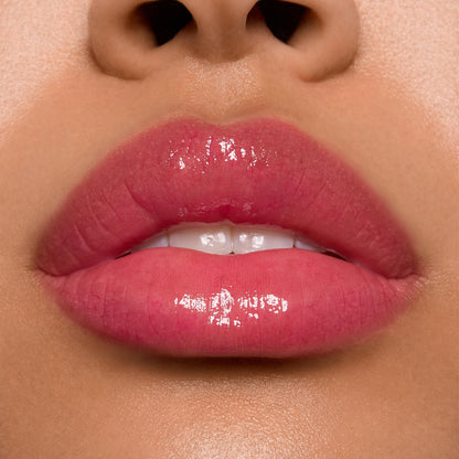 Glossy lips wearing ColourPop Ultra Glossy Lip in Surfer Vibes, delivering a sheer rosy pink tint with a high-shine, glassy finish in a tight studio close-up that highlights even coverage and reflective shine.