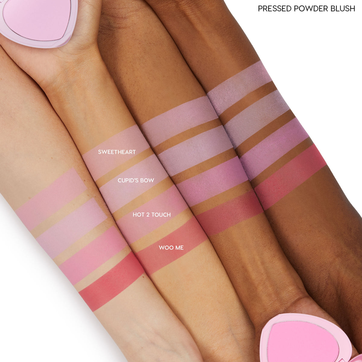 Hot 2 Touch ColourPop Pressed Powder Blush swatched on light, medium, and deep skin tones, showing a warm rose‑pink stripe beneath companion shades Sweetheart, Cupid’s Bow, and Woo Me; heart-shaped pink compact peeks at the edge.