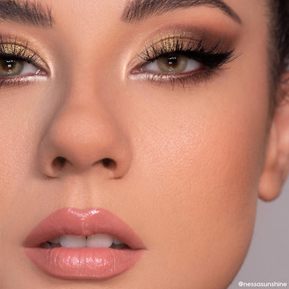 Close-up eyes wearing shimmering gold and warm brown smoky look created with 11:11 ColourPop Shadow Palette, featuring metallic lids, bright inner-corner highlight, black winged liner, full lashes, and nude glossy lips in studio lighting.
