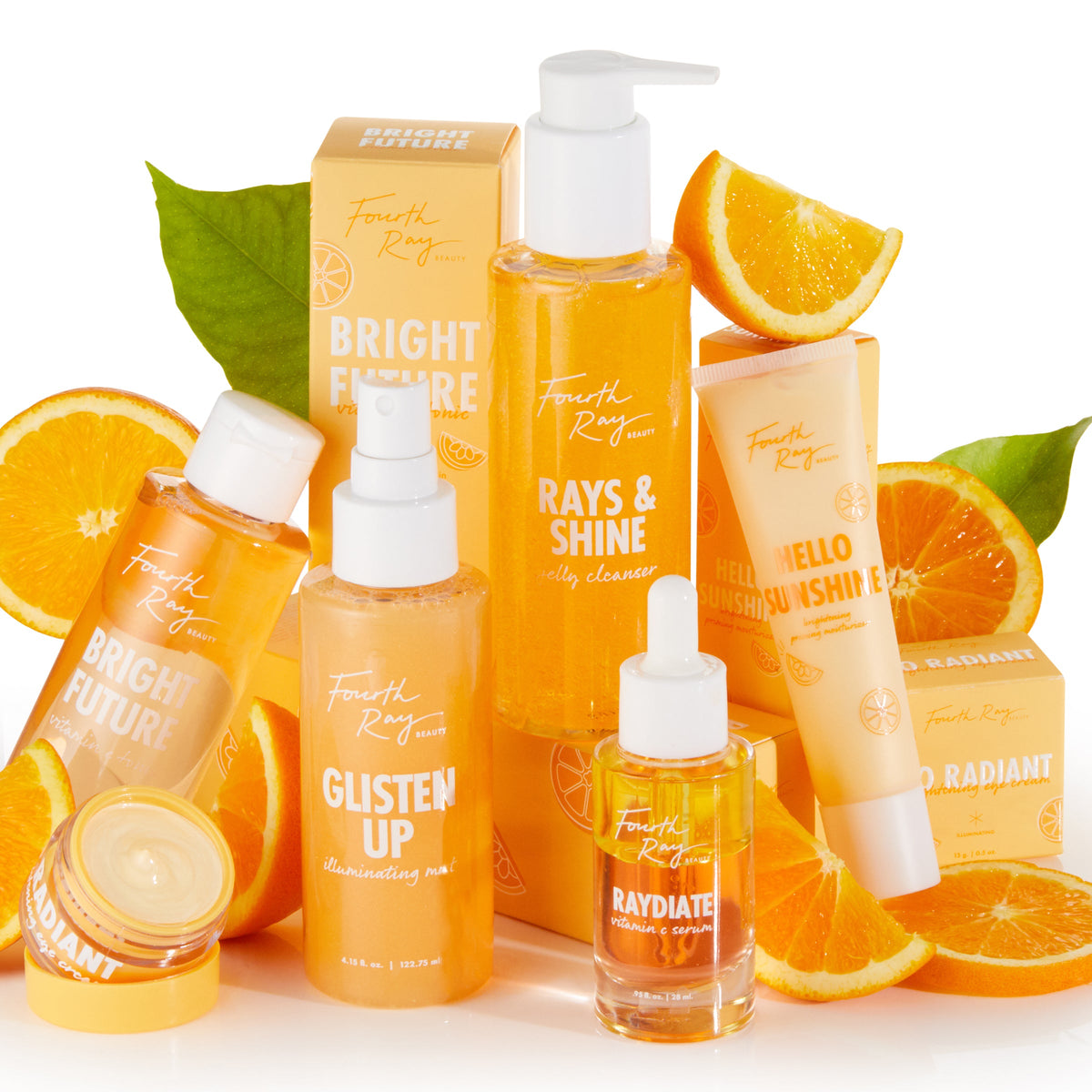 Bright Future Vitamin C Tonic by Fourth Ray Beauty stands upright among a ColourPop vitamin C collection, its orange bottle with white cap surrounded by sliced oranges and matching skincare on a bright white background.